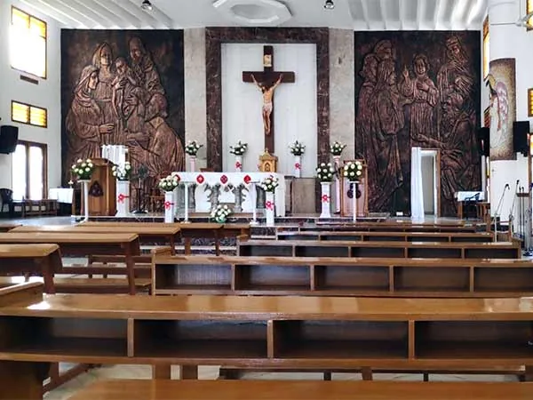 Sanctuary of Holy Family Shrine with crucifix and carved panels